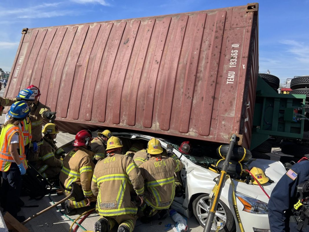 big-rig-overturns-onto-car-on-405-freeway-in-oc.,-injuring-1-and-snarling-traffic
